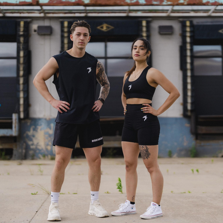 A diverse collection of mental health clothing, including biker shorts with pockets, men’s athletic tank tops, shorts with zip pockets, and a comfortable sports bra, all designed to inspire resilience and celebrate personal transformation.