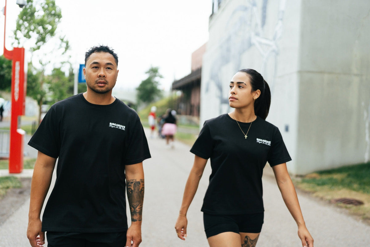 Man and woman walking in Riseabove motivational apparel, Forged In The Fire resilience clothing brand