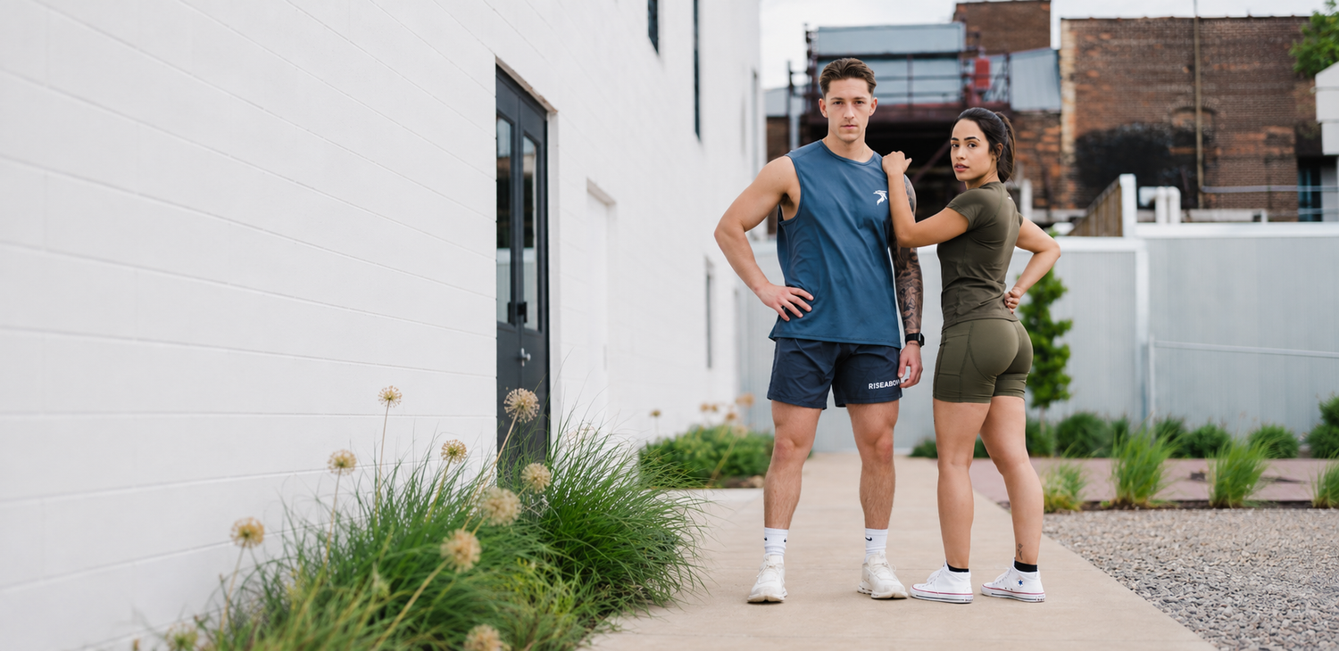 Two athletes wearing RISEABOVE apparel, representing the brand's mission of overcoming adversity through resilience, fitness, and community.