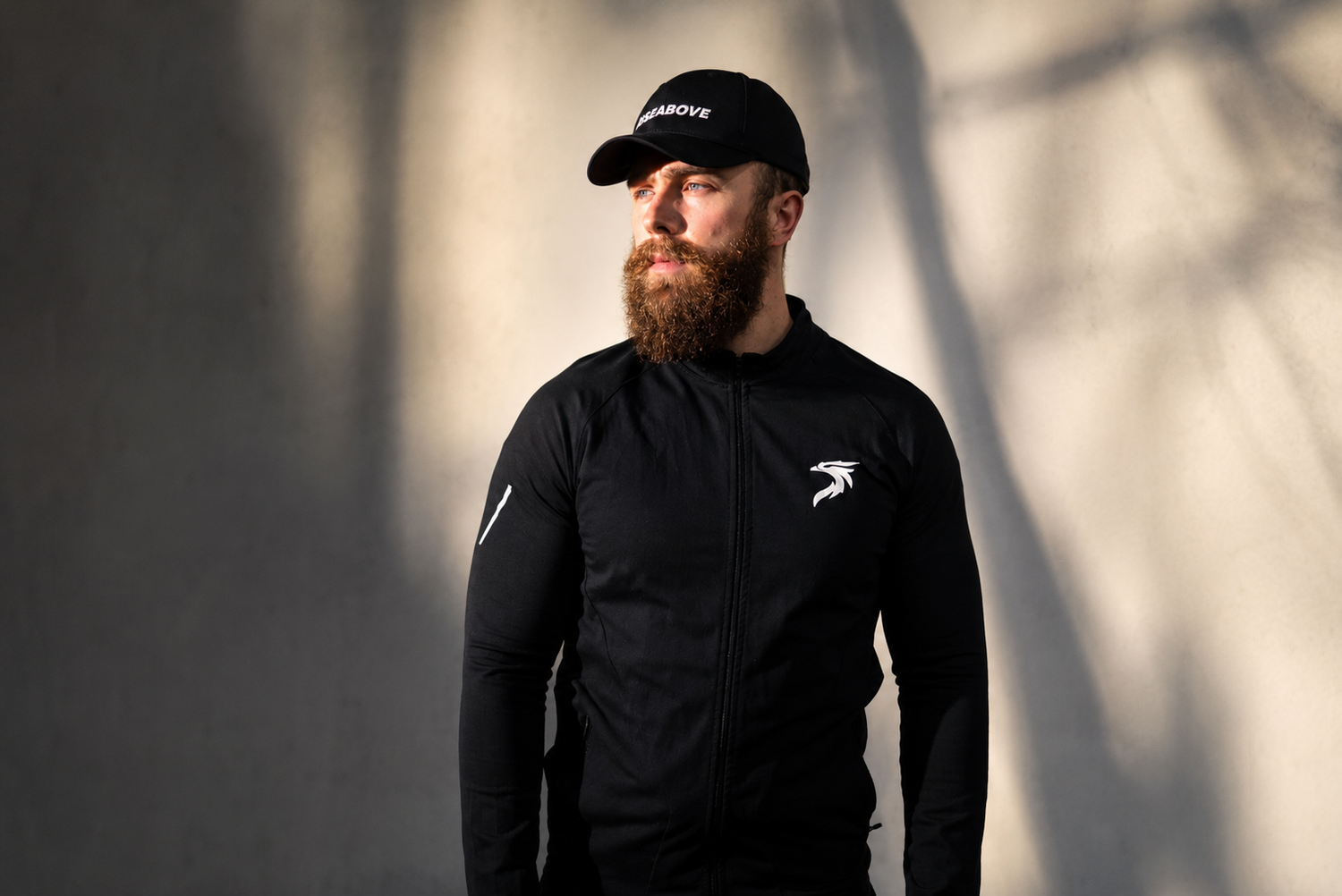 Portrait of RISEABOVE founder Dan Korte wearing RISEABOVE apparel, representing the resilience and purpose behind the brand's mission.